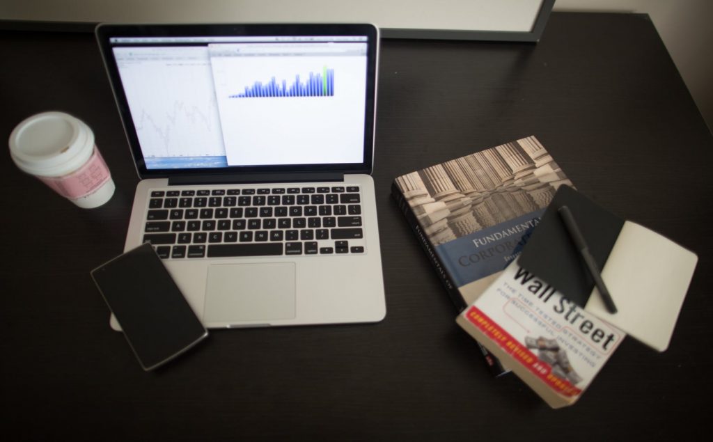 books and laptop on a desk