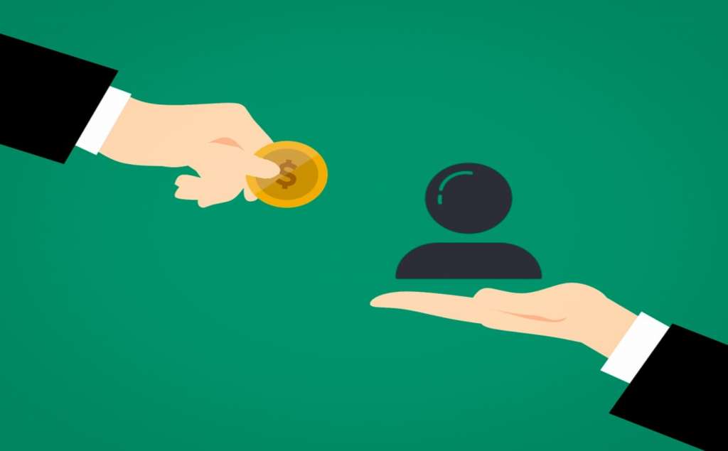 Outsourcing services shown by two hands which exchange money for talent